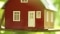 The picture shows a model house on the branch of a tree as a sign of energy self-sufficiency